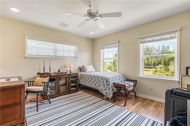 7387 61st St, Vero Beach, FL 32967 - bedroom featuring wood finished floors, visible vents, baseboards, ceiling fan, and recessed lighting