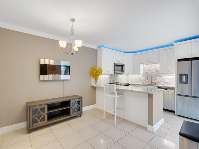 kitchen featuring white cabinetry, appliances with stainless steel finishes, sink, and kitchen peninsula