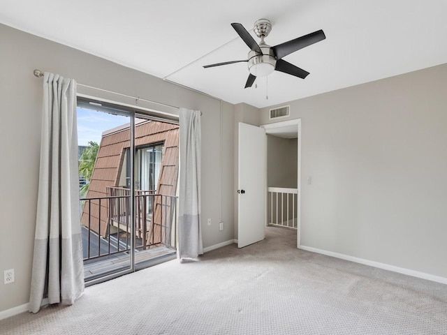 carpeted empty room featuring ceiling fan