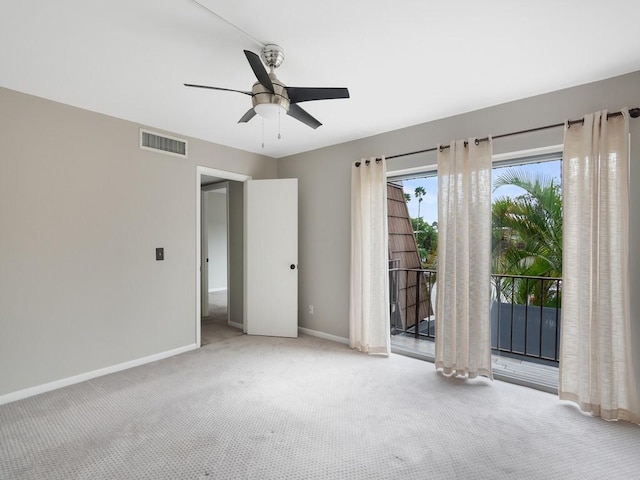 empty room with ceiling fan and light colored carpet