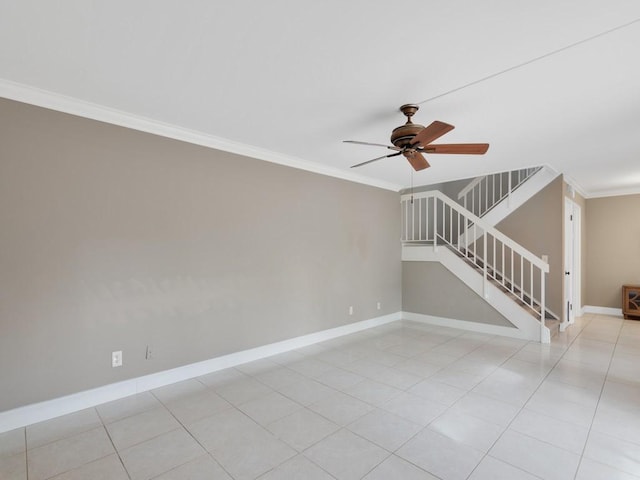 tiled spare room with ornamental molding and ceiling fan