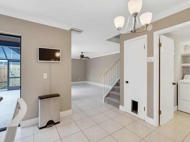 interior space with washer / clothes dryer, ornamental molding, light tile patterned flooring, and a chandelier