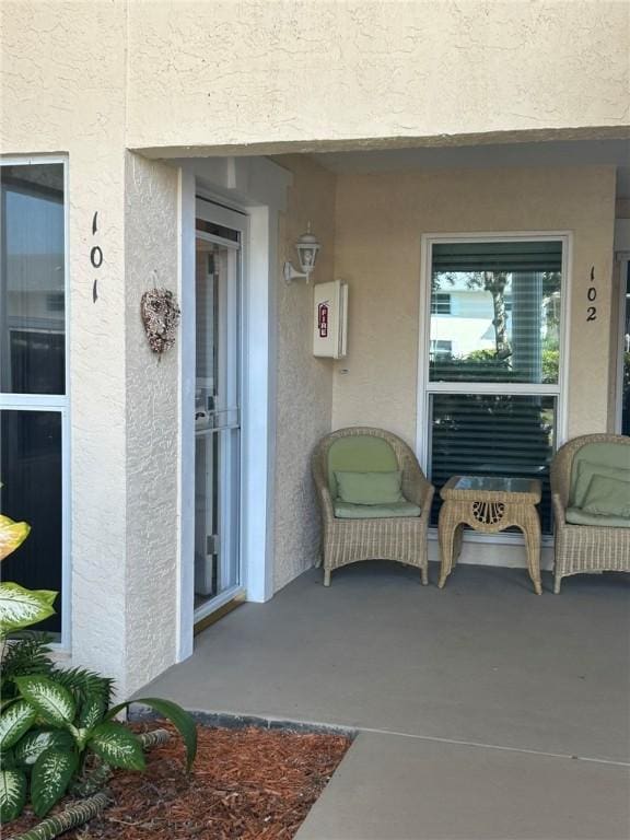 entrance to property featuring a patio area