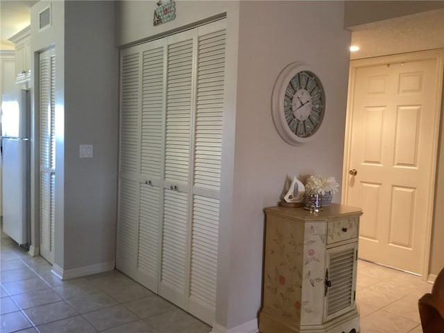 hallway with light tile patterned flooring