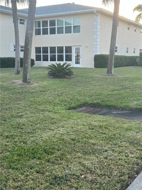 rear view of house with a yard