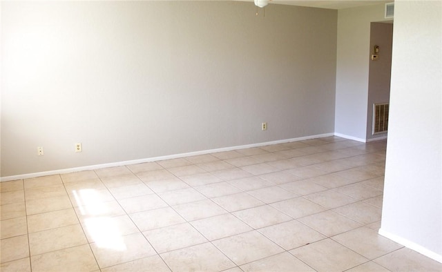 unfurnished room featuring light tile patterned floors, visible vents, and baseboards