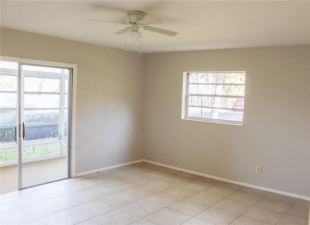 unfurnished room featuring ceiling fan and baseboards