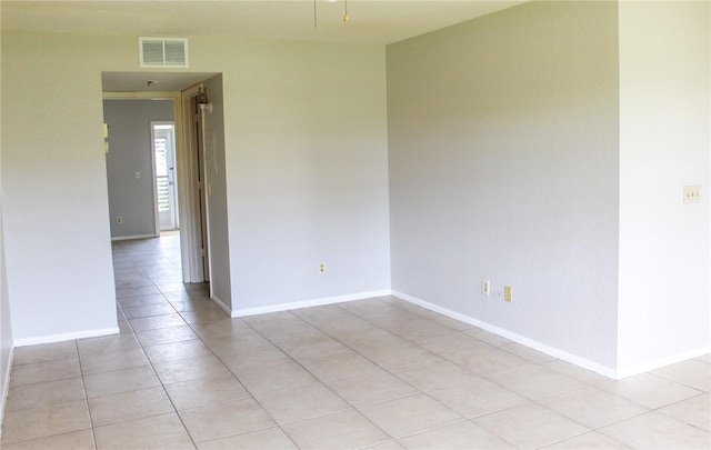 unfurnished room with light tile patterned floors, baseboards, and visible vents