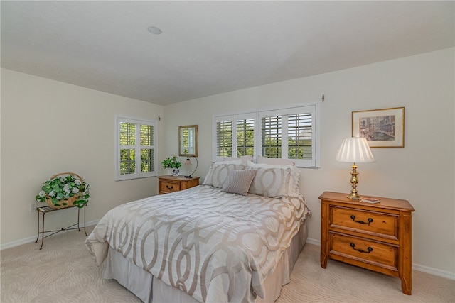 carpeted bedroom featuring multiple windows