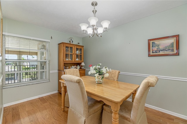 dining room featuring an inviting chandelier and light hardwood / wood-style flooring