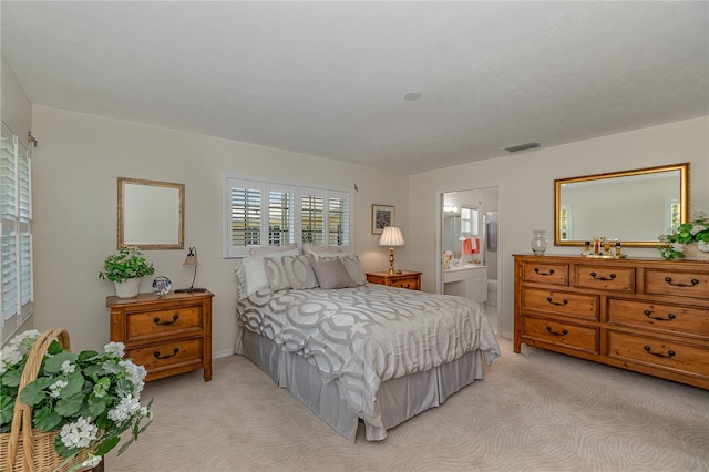 carpeted bedroom featuring ensuite bathroom