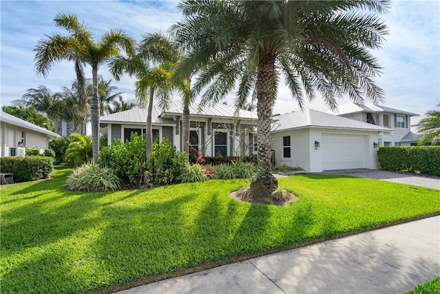 view of front of house with a garage and a front lawn