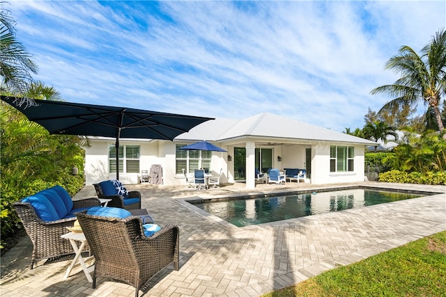 view of pool with ceiling fan and a patio area