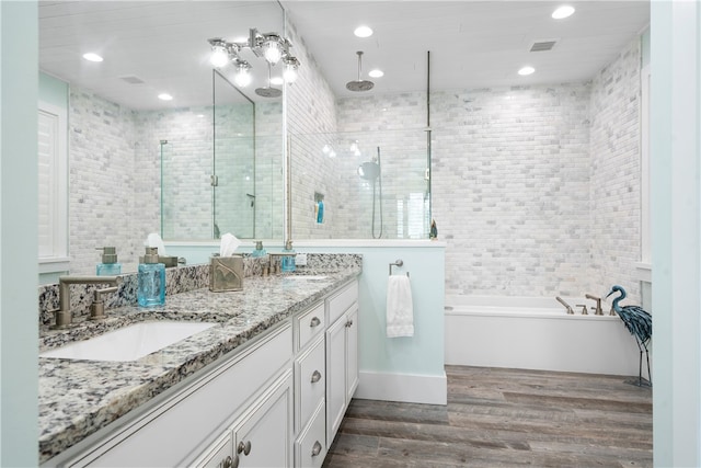 bathroom featuring shower with separate bathtub, hardwood / wood-style flooring, and vanity