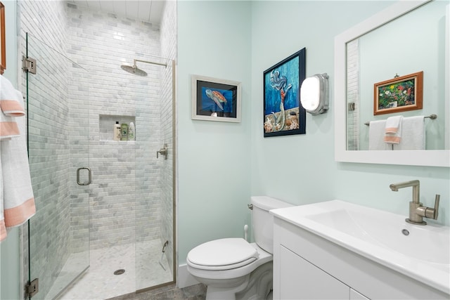 bathroom with walk in shower, vanity, and toilet