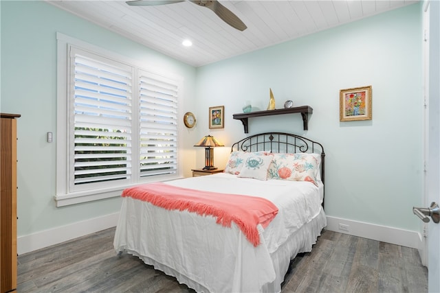 bedroom with ceiling fan and dark hardwood / wood-style floors