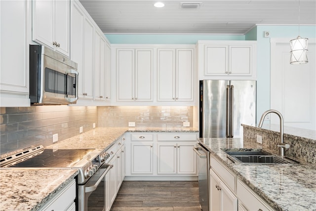 kitchen with white cabinetry, hardwood / wood-style floors, appliances with stainless steel finishes, and sink