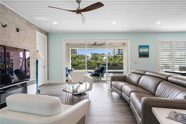 living room featuring light wood-type flooring, wood ceiling, and ceiling fan