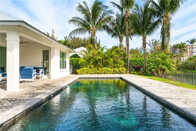 view of pool featuring ceiling fan and a patio