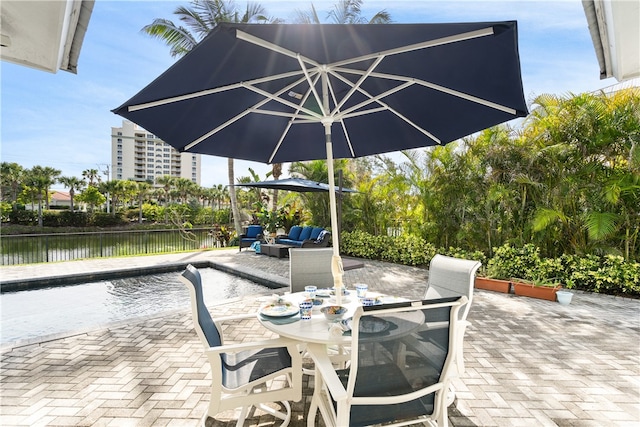 view of patio featuring an outdoor living space and a water view