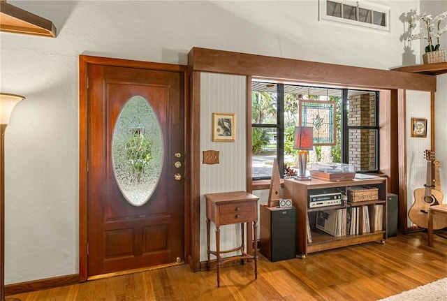 entryway featuring baseboards and wood finished floors