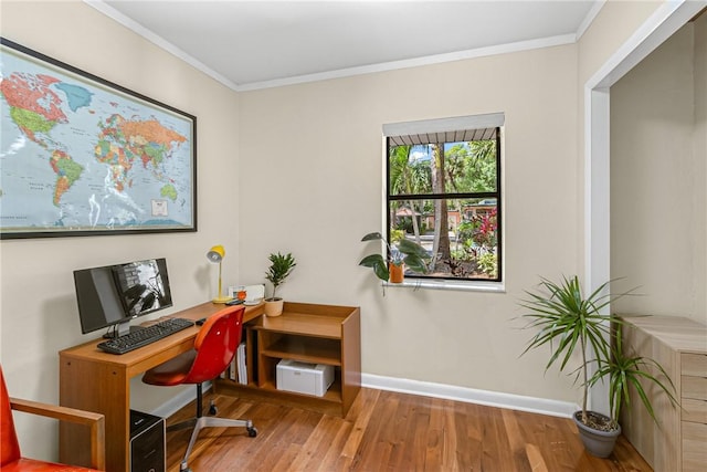 home office featuring ornamental molding, wood finished floors, and baseboards