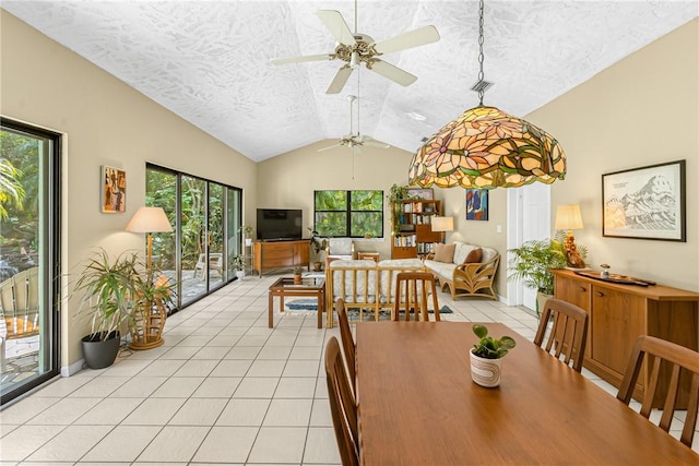 dining room featuring ceiling fan, vaulted ceiling, a textured ceiling, and light tile patterned floors