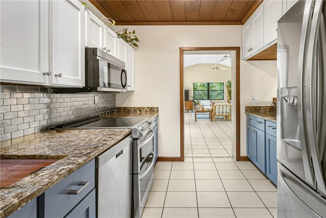 kitchen with stainless steel appliances, decorative backsplash, wood ceiling, white cabinets, and light tile patterned flooring