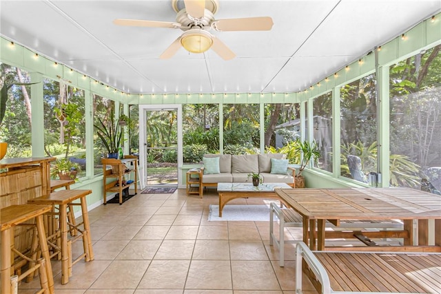 sunroom featuring a ceiling fan