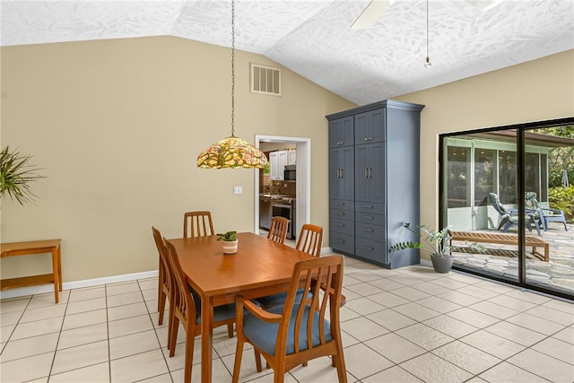 dining area with visible vents, light tile patterned flooring, vaulted ceiling, a textured ceiling, and baseboards