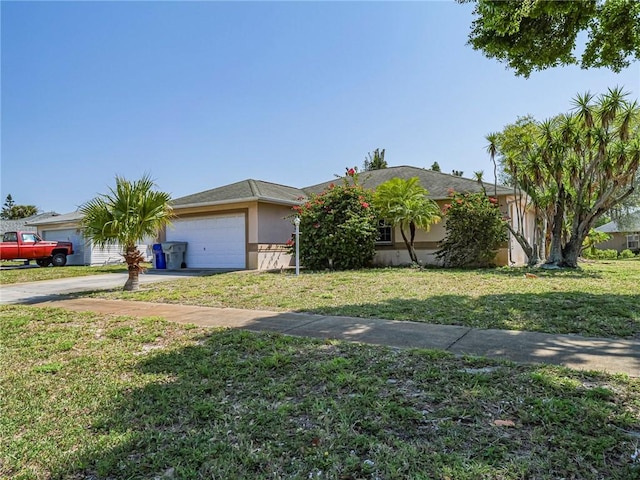 view of front of home with stucco siding, an attached garage, concrete driveway, and a front lawn