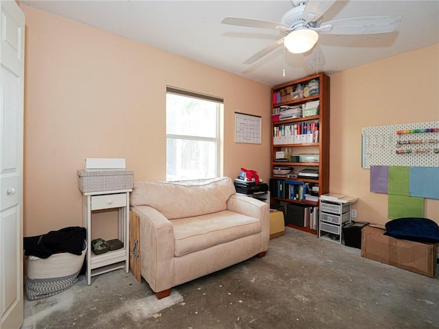 living area with unfinished concrete flooring and ceiling fan