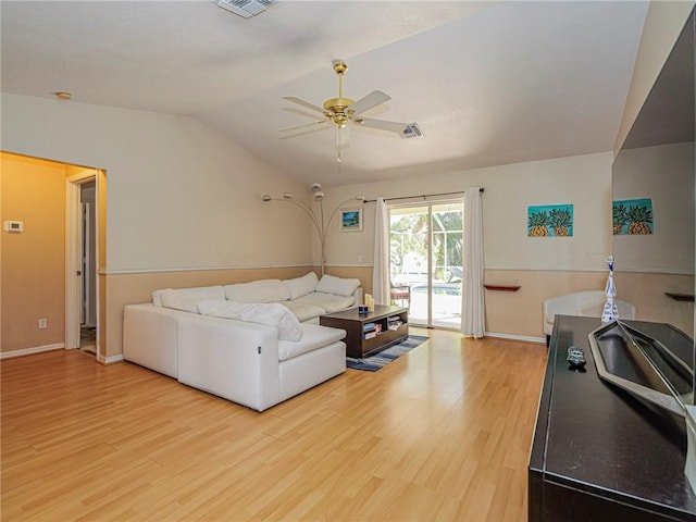 living room with visible vents, light wood-style flooring, ceiling fan, and vaulted ceiling