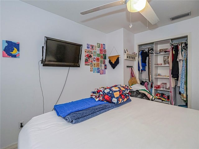 bedroom with a closet, visible vents, and a ceiling fan