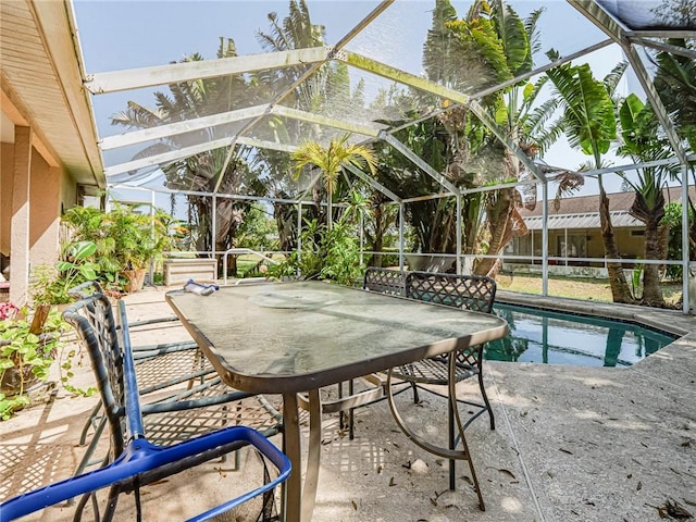 outdoor pool with glass enclosure, outdoor dining area, and a patio area