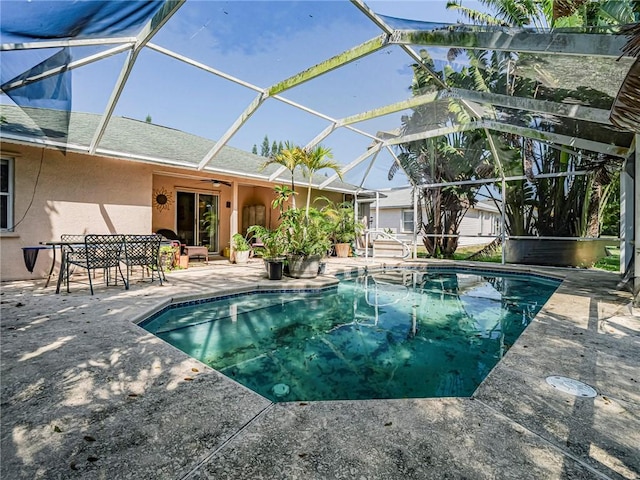 pool featuring a lanai, ceiling fan, and a patio area