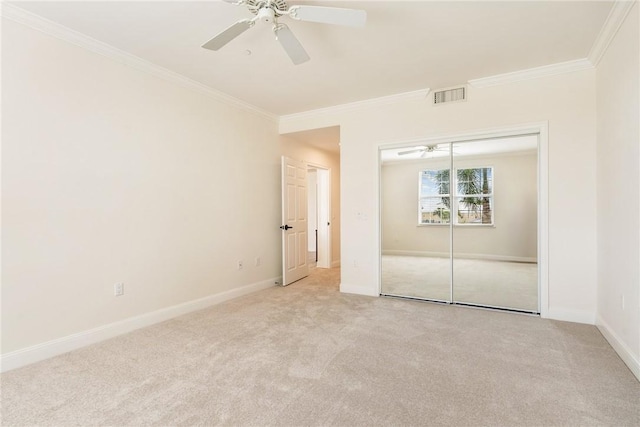1510 Oak Harbor Blvd Unit 202, Vero Beach, FL 32967 - unfurnished bedroom featuring crown molding, light carpet, a closet, and ceiling fan