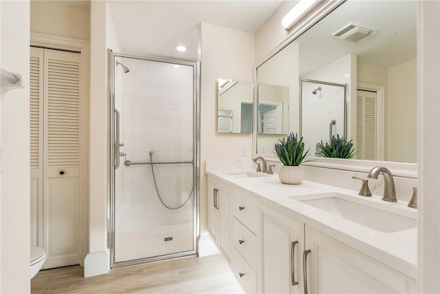 1510 Oak Harbor Blvd Unit 202, Vero Beach, FL 32967 - bathroom with a closet, a shower stall, double vanity, and recessed lighting