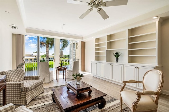 1510 Oak Harbor Blvd Unit 202, Vero Beach, FL 32967 - living area with light wood finished floors, ceiling fan, built in features, and a raised ceiling