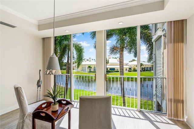 1510 Oak Harbor Blvd Unit 202, Vero Beach, FL 32967 - doorway with a water view, a tray ceiling, wood finished floors, crown molding, and a residential view
