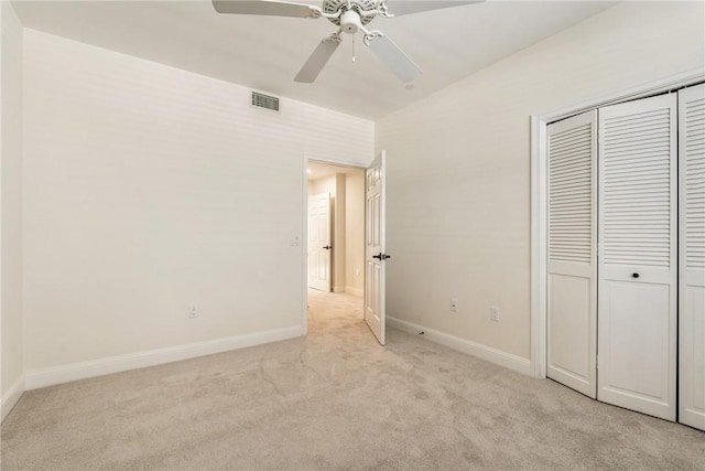 1510 Oak Harbor Blvd Unit 202, Vero Beach, FL 32967 - unfurnished bedroom with light carpet, a closet, and a ceiling fan