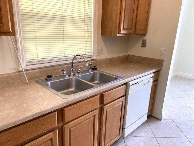 kitchen with sink, light tile patterned floors, and white dishwasher