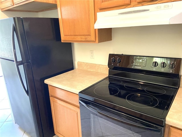 kitchen featuring light tile patterned floors and black appliances