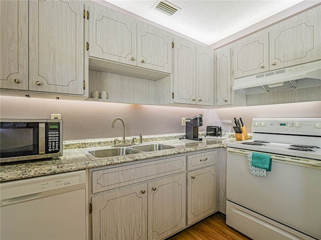 kitchen with white appliances, a textured ceiling, sink, and dark hardwood / wood-style flooring