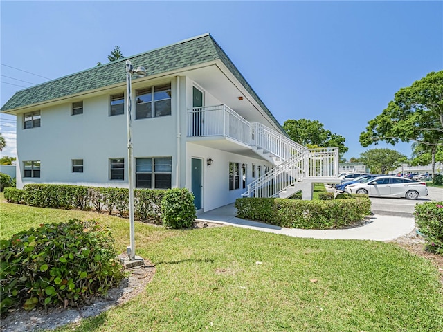 view of property exterior featuring a lawn