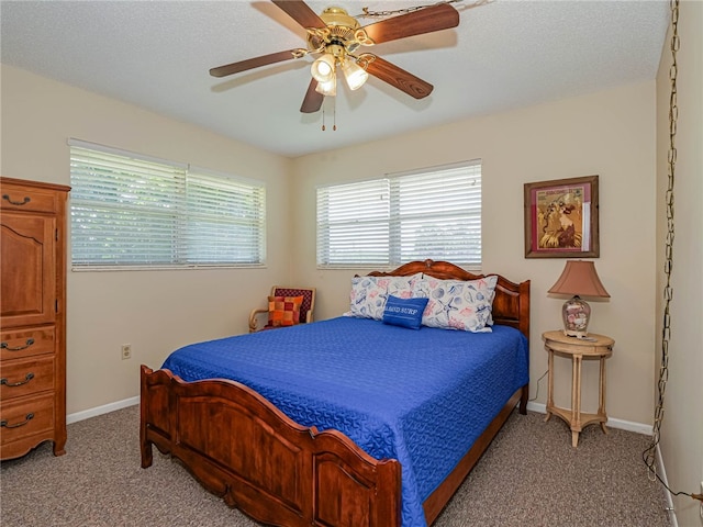 bedroom with ceiling fan, a textured ceiling, and light carpet