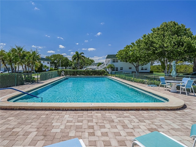 view of swimming pool featuring a patio area