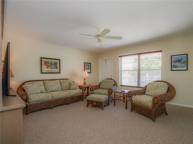 living room featuring ceiling fan, a textured ceiling, and light colored carpet