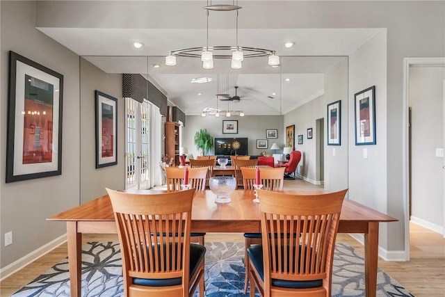 dining room with ceiling fan, light hardwood / wood-style floors, ornamental molding, and vaulted ceiling