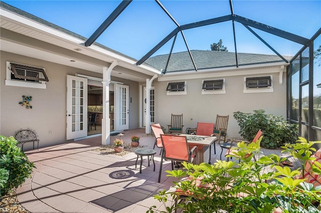 view of patio with a wall mounted AC, french doors, and glass enclosure